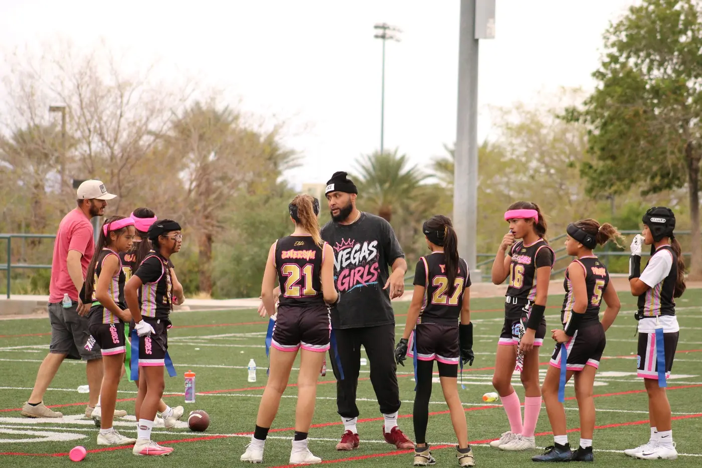 Vegas Girls athletes listening during a team talk
