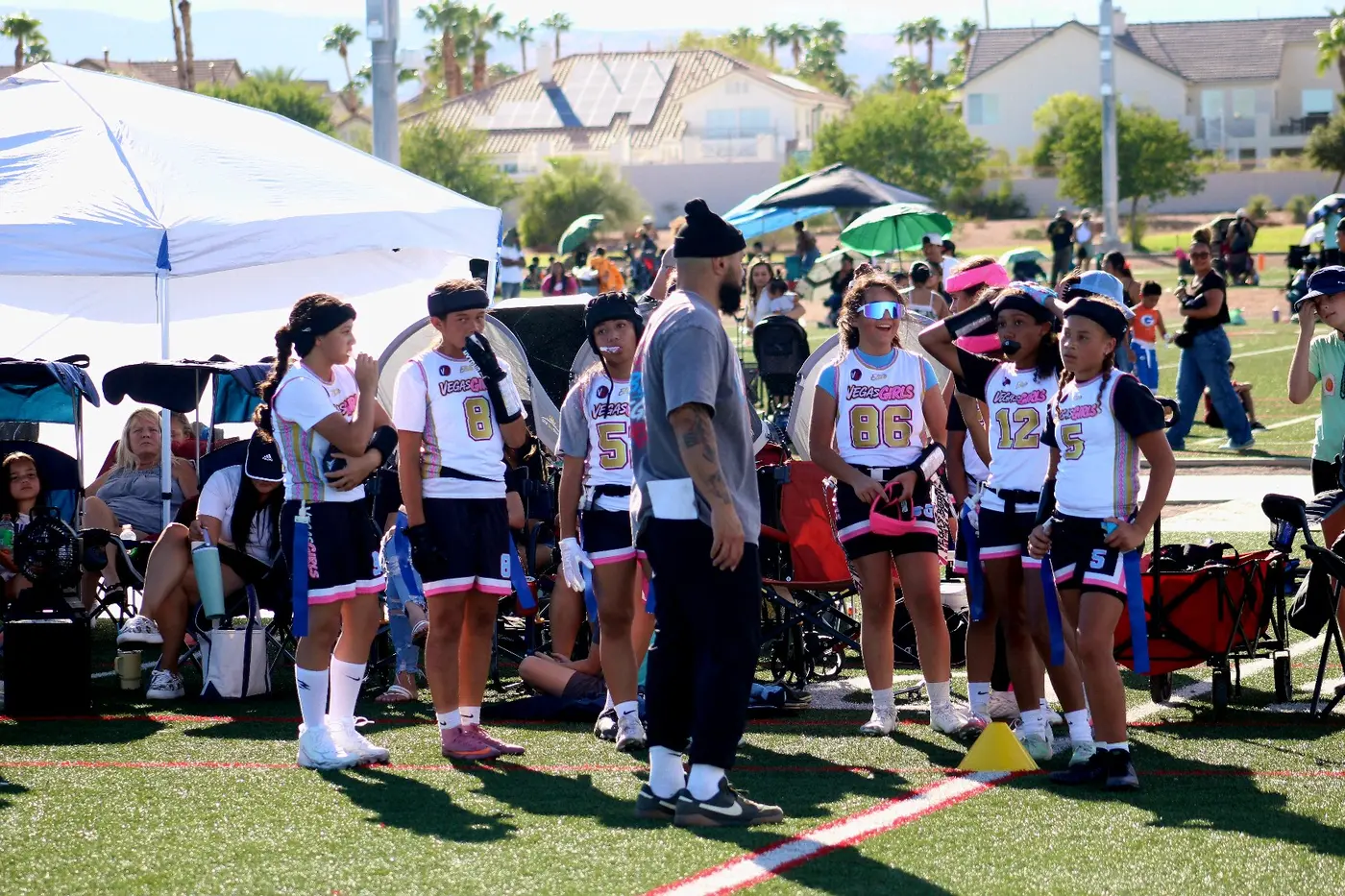 Vegas Girls athletes together on the sideline